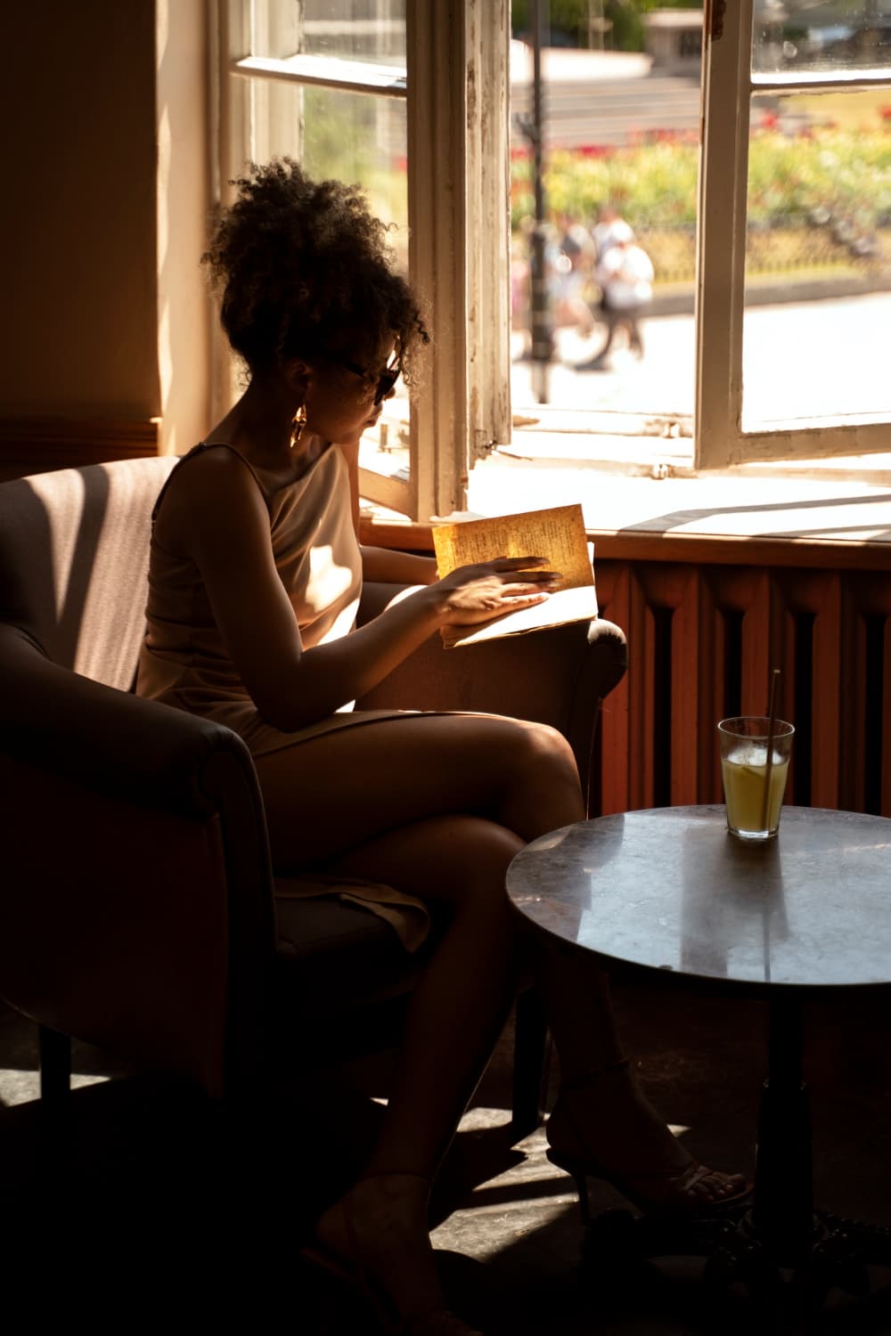 Une lectrice absorbée par son livre dans une lumière dorée